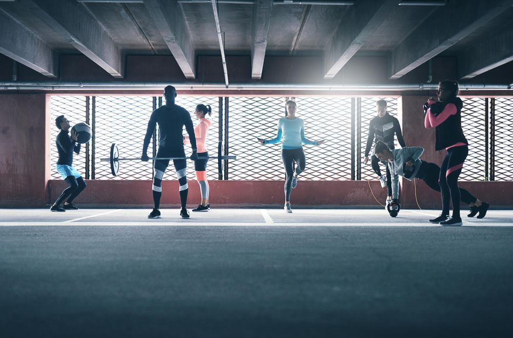 People doing circuit training in front of a sunny window