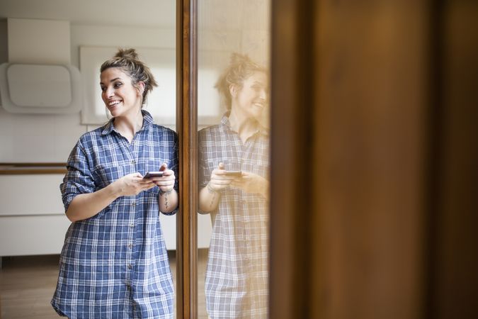 Woman at home on the mobile phone