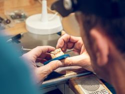 Crop orthodontist technician making jaws casts in laboratory