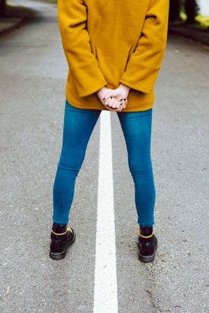 Anonymous woman standing on road