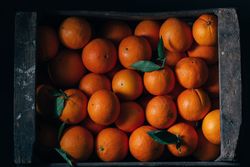 Fresh oranges in an old wooden box