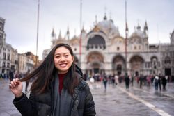 Traveler exploring city with historical buildings and waterlines