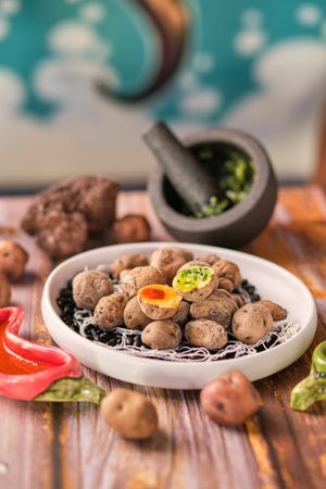 Plate of boiled potatoes near mortar and pestle