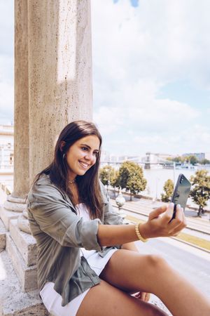 Woman taking selfie on old building