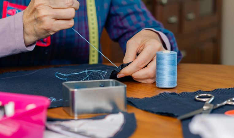 female seamstress sewing cloth