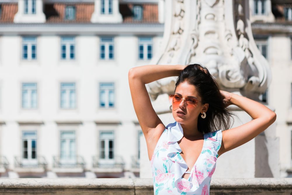 stylish woman in sunglasses sitting in street stairs