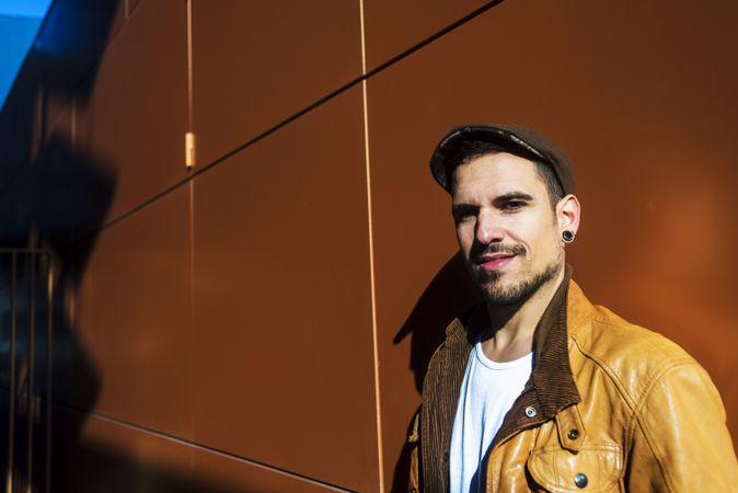Confident guy leaning on wall