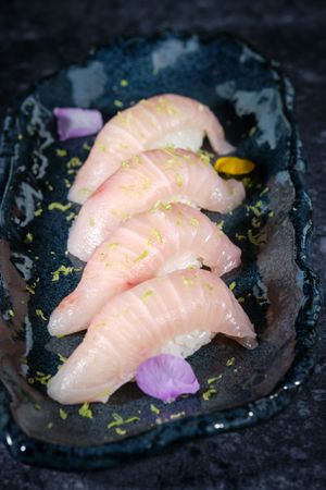 Sushi served in row on plate