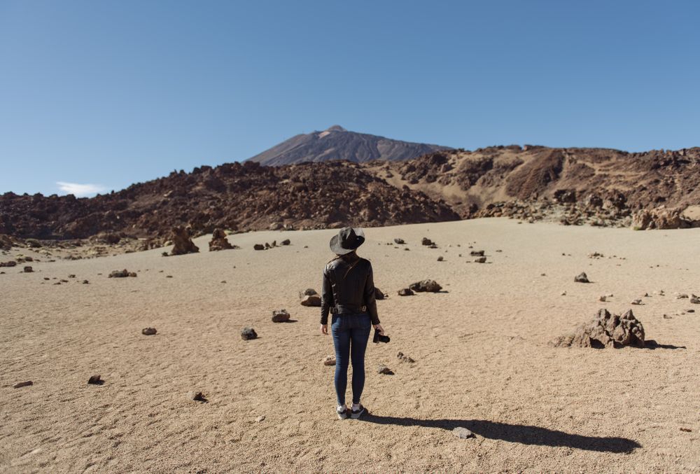 Woman with camera in desert