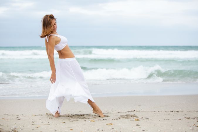 woman dancing near sea