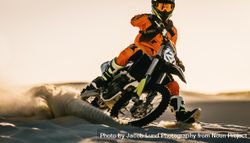 Dirt biker accelerating and turning on motocross trail 47Opr4