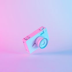Vintage camera in vibrant bold gradient purple and blue holographic colors