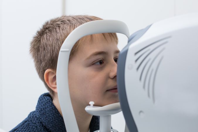Optician testing a boy's eyes