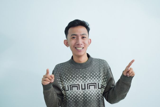 Asian young man pointing