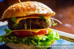 Side view of hamburger with lettuce, tomatoes & cheese 5XrNPQ