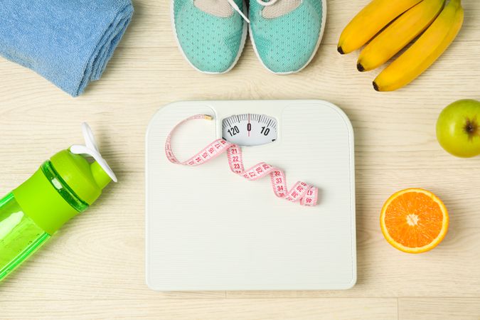 Healthy lifestyle accessories on neutral background, top view