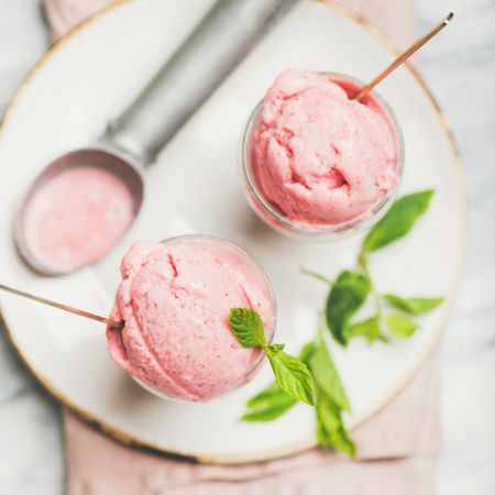 Homemade strawberry yogurt ice cream with fresh mint, square crop