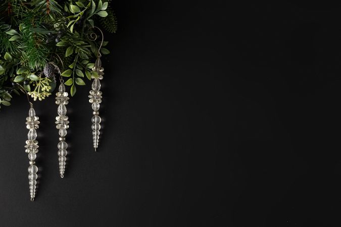 Festive icicles and leaves on dark background