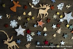 Top view of flat cut out Christmas ornaments scattered on table bePAE4