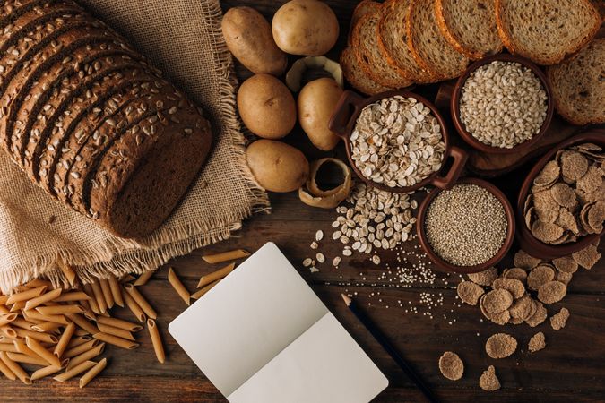 Wholegrain food and freshly baked rye bread on table
