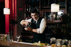 Barman working mixing drinks in a shaker