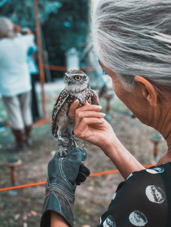 Older woman holding owl