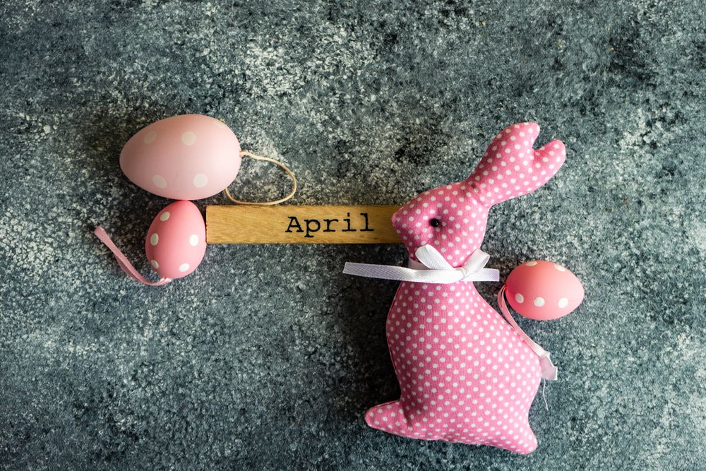 Easter card concept of grey counter with decorative small pink eggs and rabbit ornament