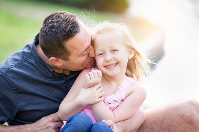 Father and Daughter Having Fun At The Park