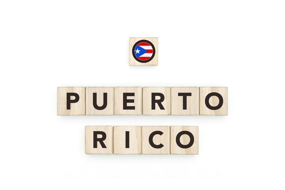 Wooden blocks bearing the name and flag of Puerto Rico. Puerto Rican and Caribbean Culture, national identity, travel, and geography in a copy space design.