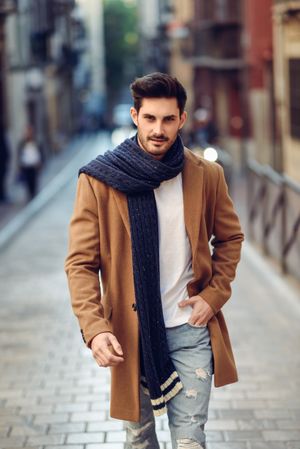 Man in scarf while walking down the street