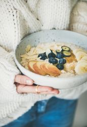 Close up of organic oatmeal with fruits, nuts, and honey