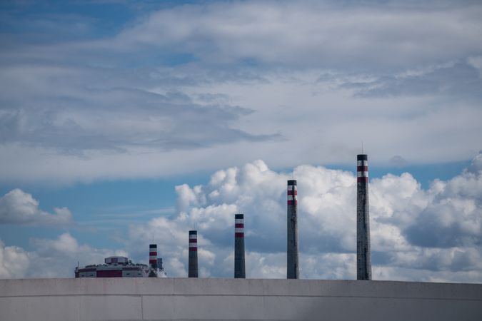 Industrial smoke stacks and beautiful cloudy sky