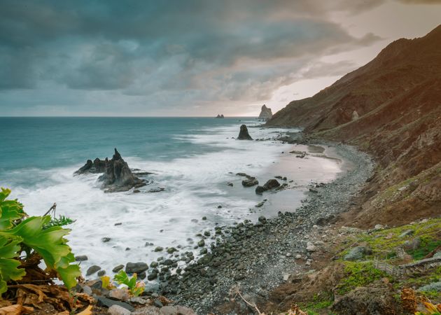 Lonely cliff in sea on cloudy day