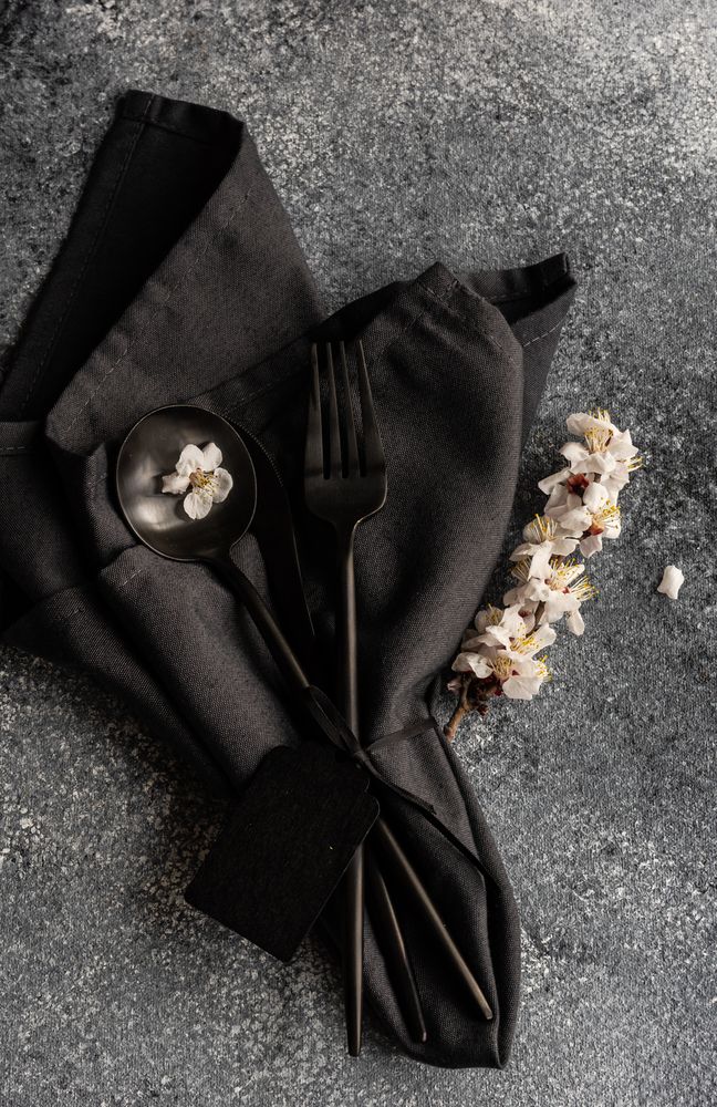 Spring floral concept with top view of apricot blossom branch wrapped in dark napkin