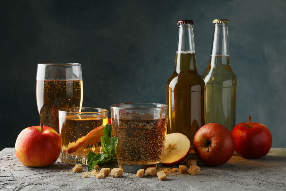 Composition with cider, sugar and apples on gray background