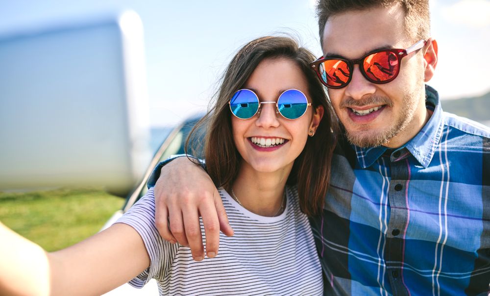 Young couple doing a selfie on the car