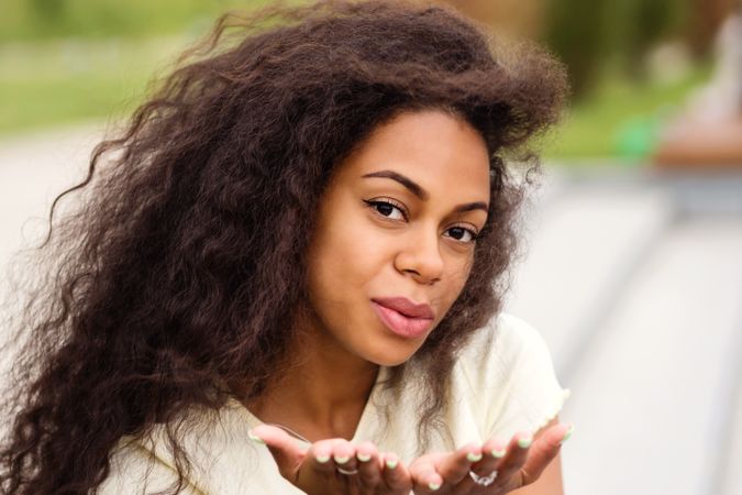 Portrait of Black female air kissing the camera