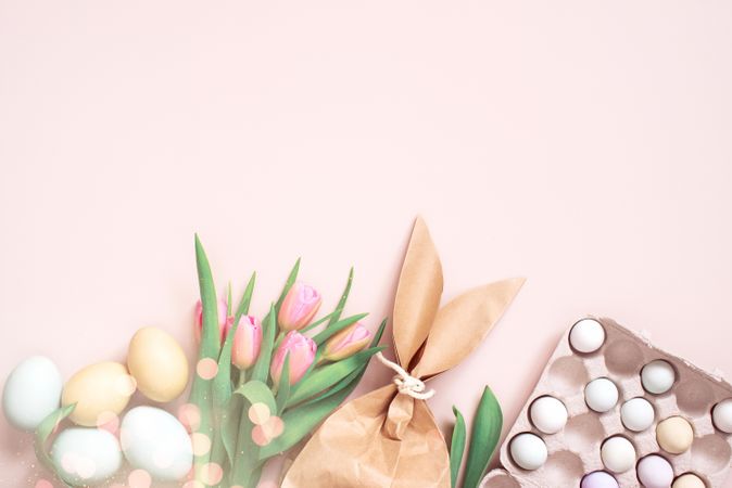 Flat lay of Easter eggs, tulips and paper bag with copy space