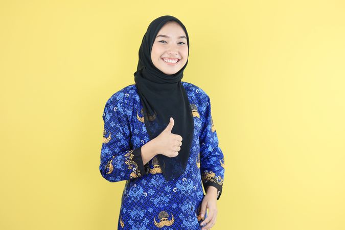 Indonesian CIvil Servant Wearing Korpri Uniform and Hijab, Gesture Thumbs Up