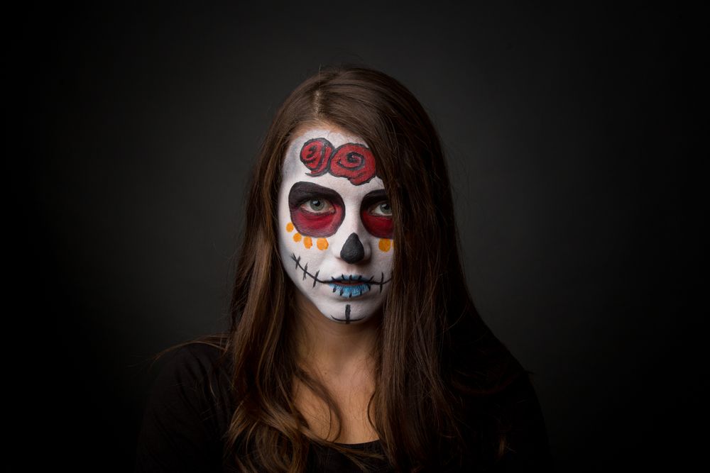 Young woman with creepy face paint