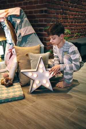 Male teen helping preparing a slumber party