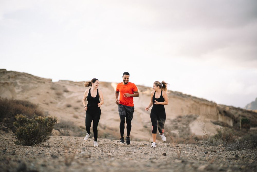 Multiracial friends jogging on nature together