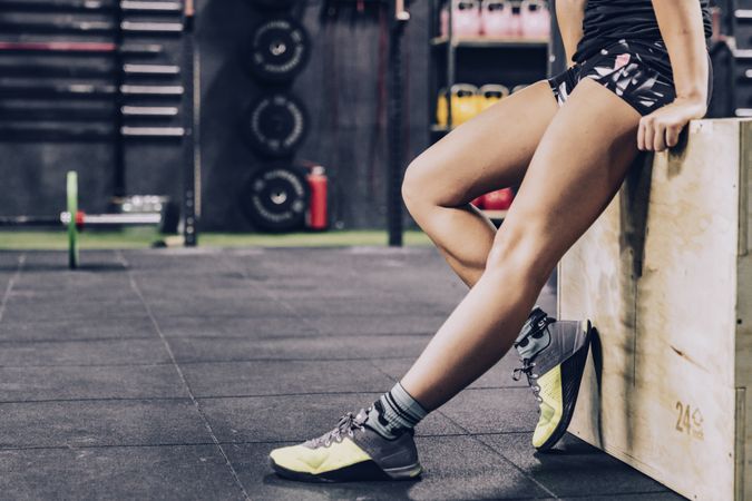 Slender woman having break in fitness club