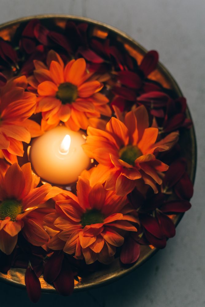 Lit candle in the middle of bowl