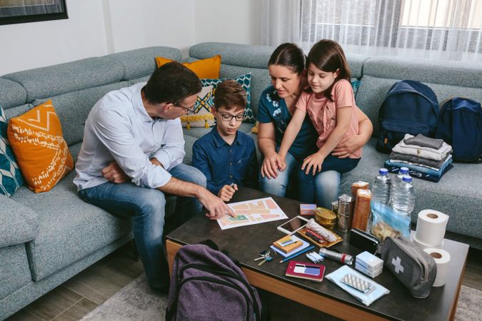 Father explaining to his family the emergency assembly point