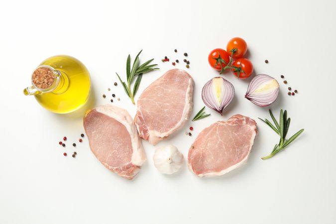 Composition with raw meat and ingredients on light background, top view