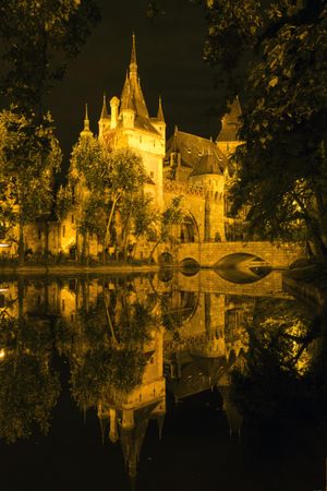 Evening shot of Vajdahunyad Castle in Budapest on reflective lake