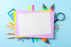 Flat lay composition with school supplies on color background, space for text