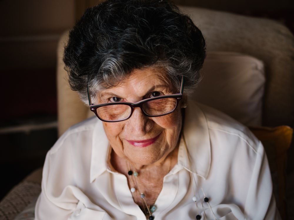 Portrait of older female in white shirt at home