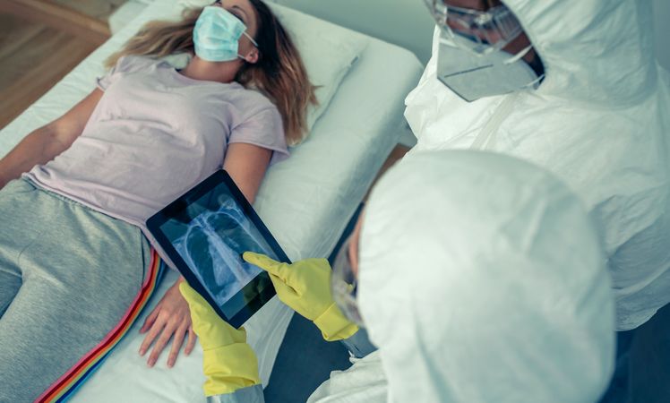 Doctors examining a patient's chest x-ray
